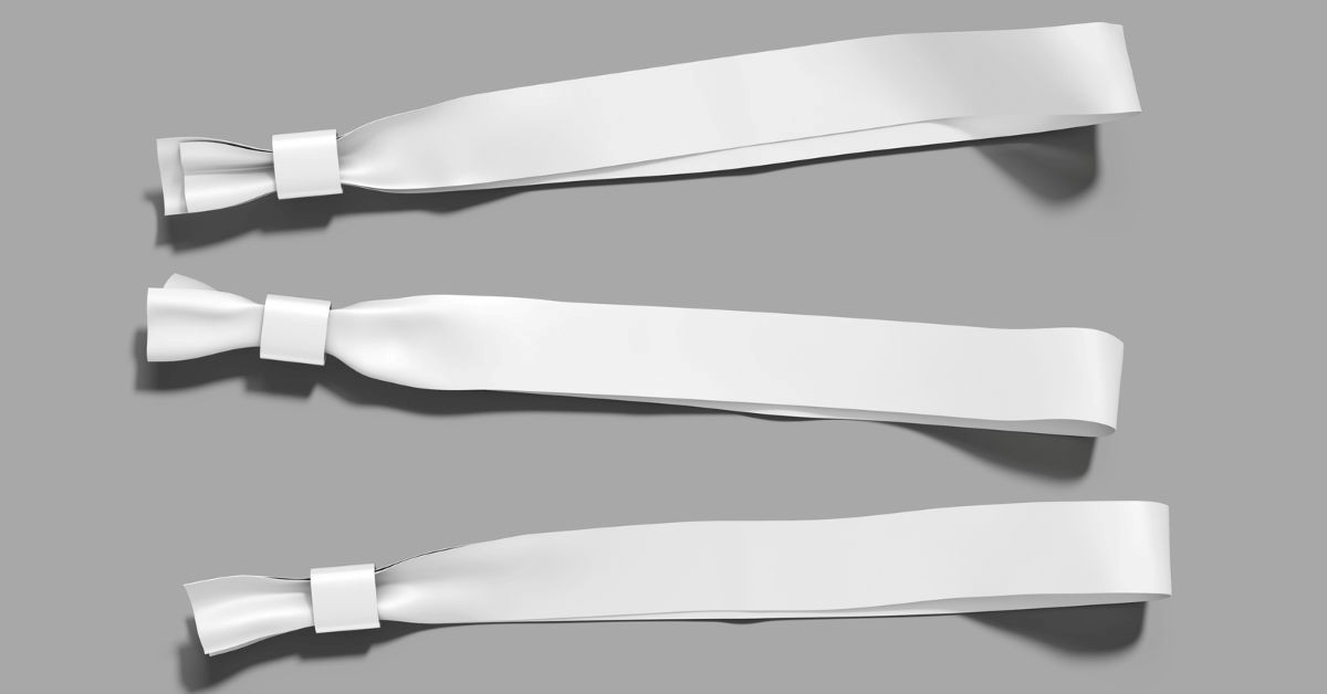 Three blank fabric wristbands with sliding locks on a neutral background