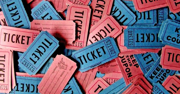 Pile of red and blue raffle tickets including keep-this-coupon stubs