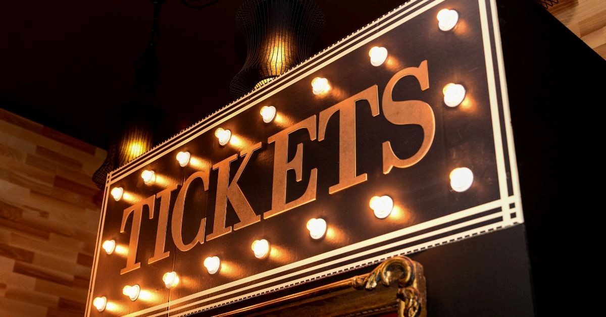 Retro marquee sign with the word TICKETS illuminated by bulbs