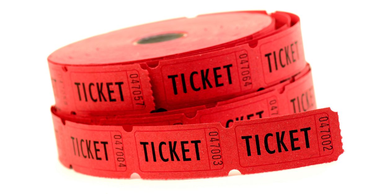Close-up of red raffle ticket roll showing KEEP THIS COUPON and serial numbers
