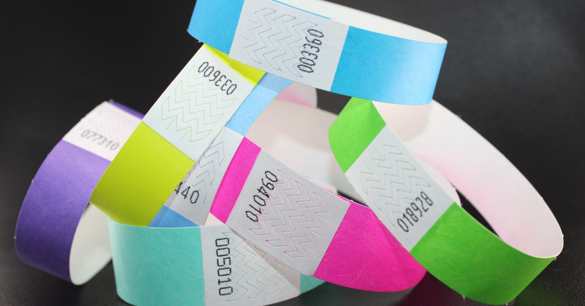 Assorted custom Tyvek wristbands showing different colors and printed designs