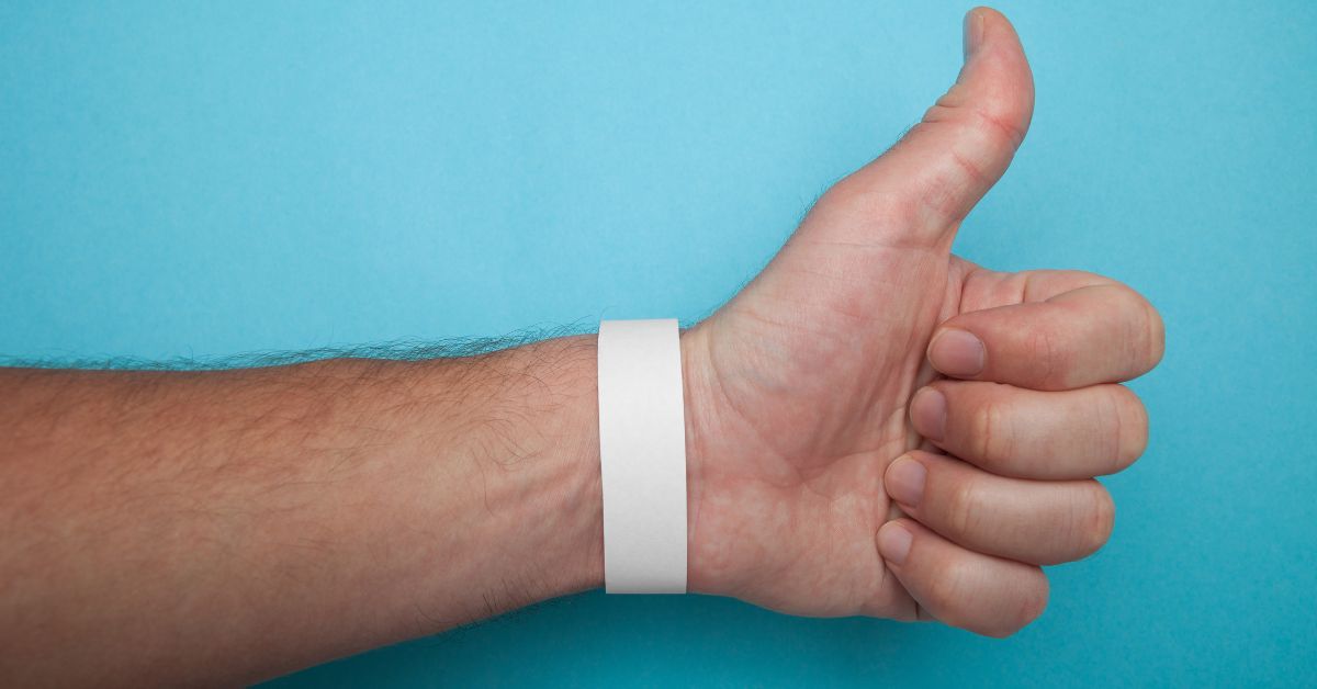 Entry staff applying Tyvek wristbands during event check-in